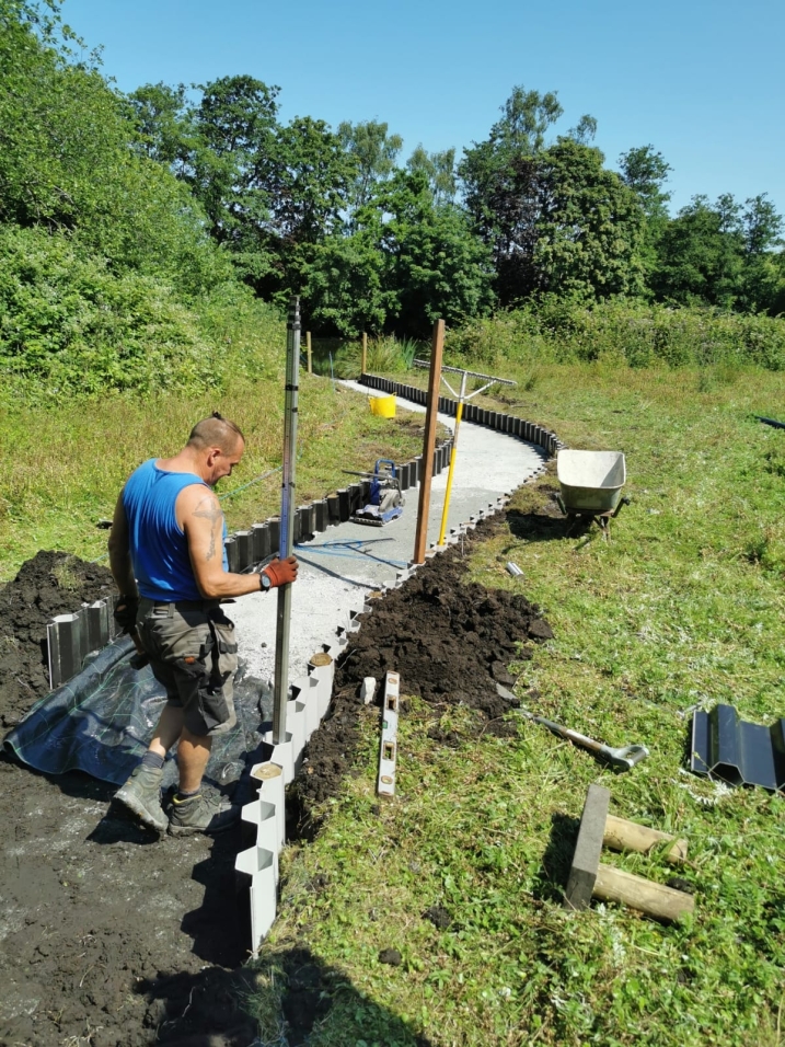 Area shows a sunken pathway being built into the ground
